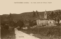 Valvignères - La route, entrée du village, l'église 